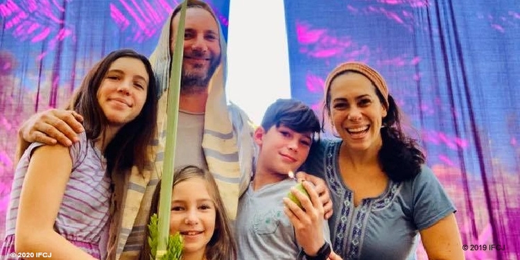 Yael Eckstein and family in sukkah for Sukkot