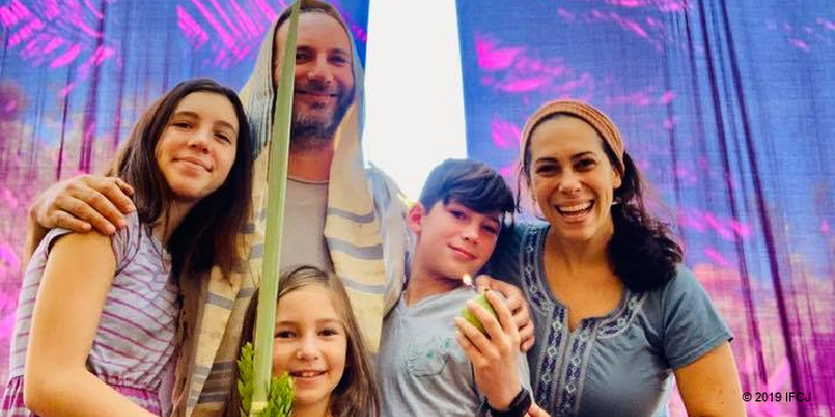 Yael Eckstein and family in sukkah for Sukkot
