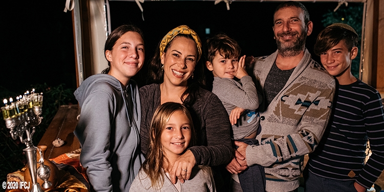 Yael and family with menorah