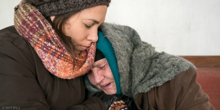 Yael embracing an elderly Jewish woman in need.
