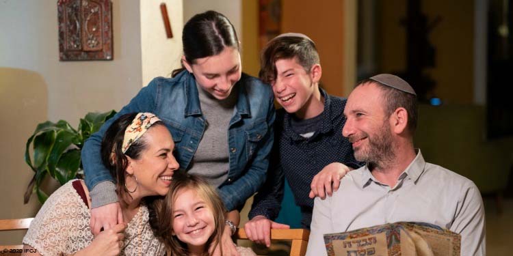 Yael smiling and embracing her family during Passover.