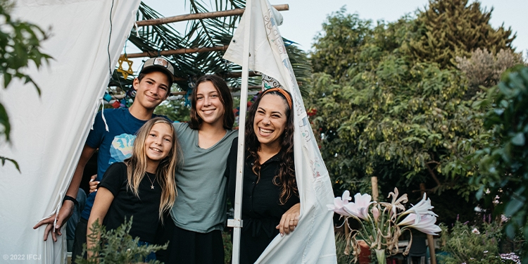 Yael and her family building a sukkah