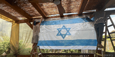 Yael and her family building a sukkah