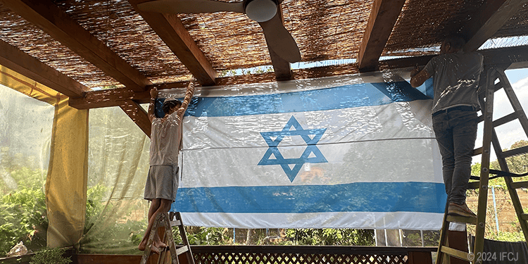 Yael and her family building a sukkah