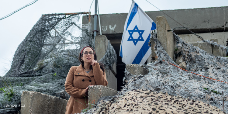 Yael Eckstein at IDF base with Israeli flag, illustrating Yom HaAtzmaut, Independence Day