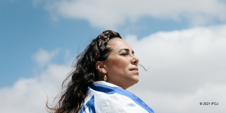 Yael wrapped in Israeli flag, illustrating her leaving the Holy Land to visit America