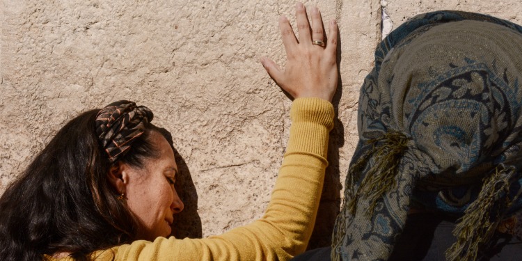 Yael with hand placed on the Western Wall in Israel