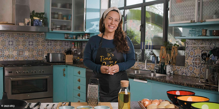 Yael in the kitchen cooking latkes