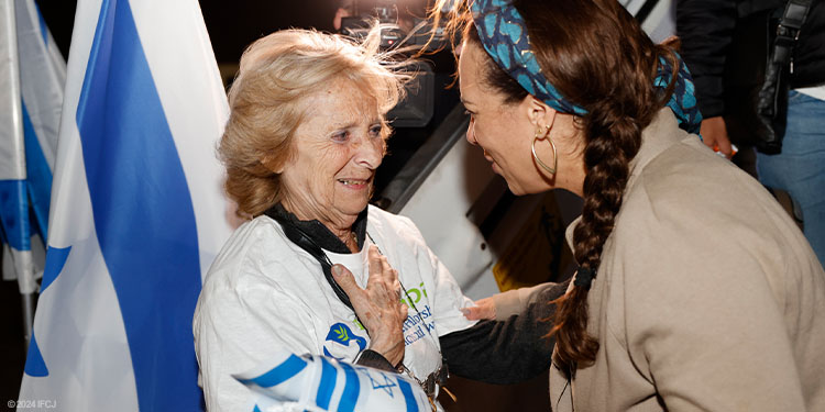 Yael greeting an elderly woman