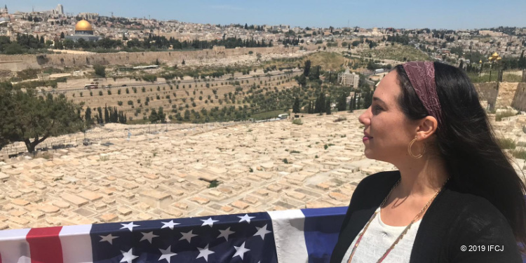 Yael Eckstein with American flag overlooking Jerusalem, illustrating US-Israel friendship as America prepares to vote