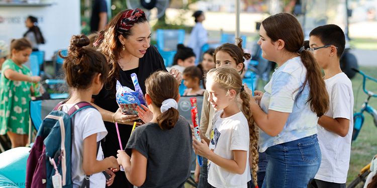 Yael surrounded by children