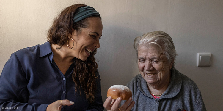 Yael visiting with elderly woman