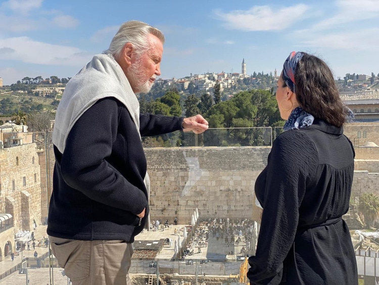 Yael Eckstein and Jon Voight having a conversation with Jerusalem in the background.