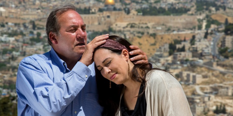 Rabbi Eckstein blessing Yael Eckstein with Jerusalem in the background.