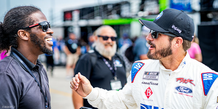 Young man smiling with race car driver