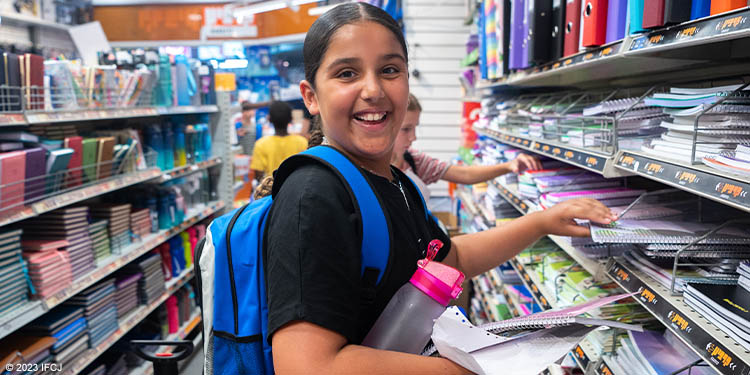 Young student purchasing school supplies