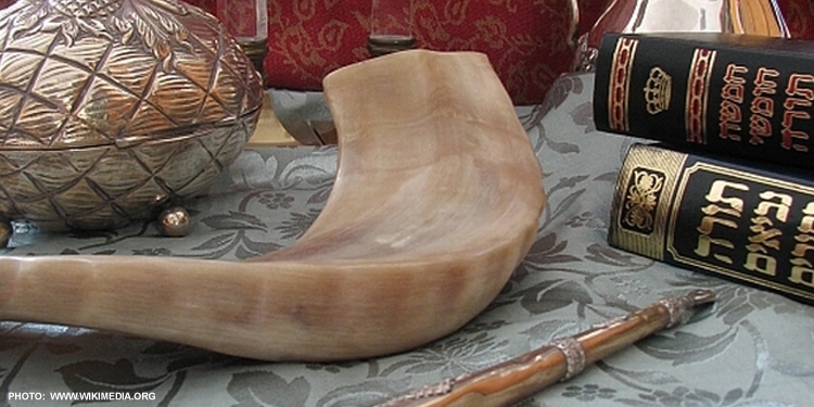 Jewish art, artifacts, and books gathered together on a table.