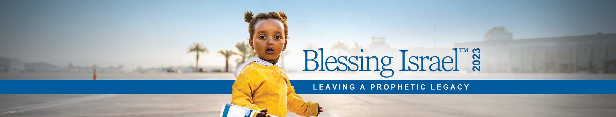 An online banner reading Blessing Israel 2023, Leaving a prophetic legacy, featuring a small Ethiopian girl in a yellow jacket holding an Israeli flag.