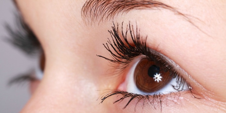 Close up image of a woman's brown eye with mascara on.