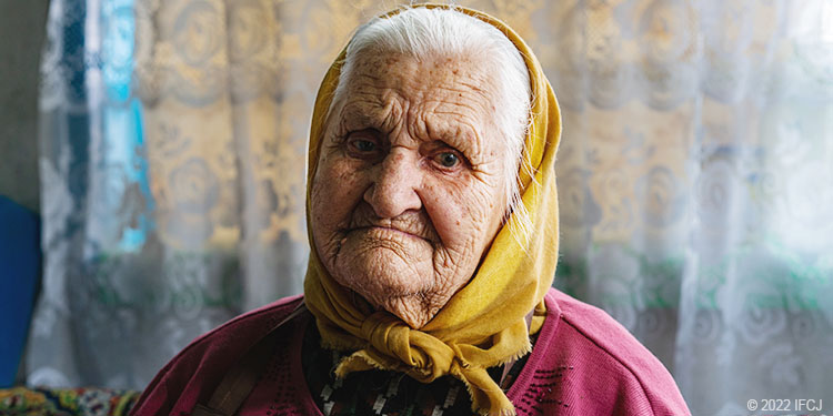 Elderly woman in yellow scarf