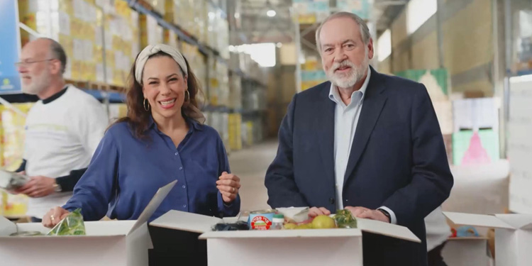 Yael Eckstein alongside Muck Huckabee as they're packing food boxes.