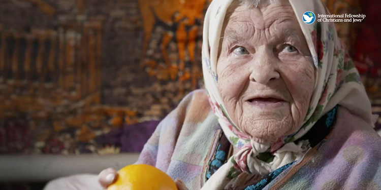 Elderly woman with orange