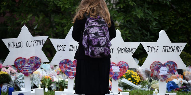 Young girl standing at a memorial.