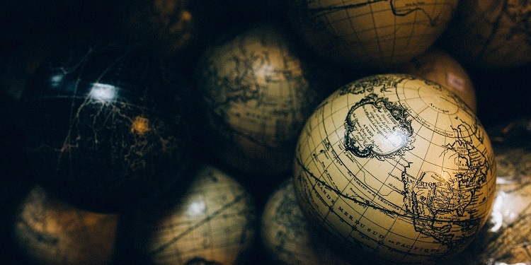 Close up image of tan globes with a map of the world on it.