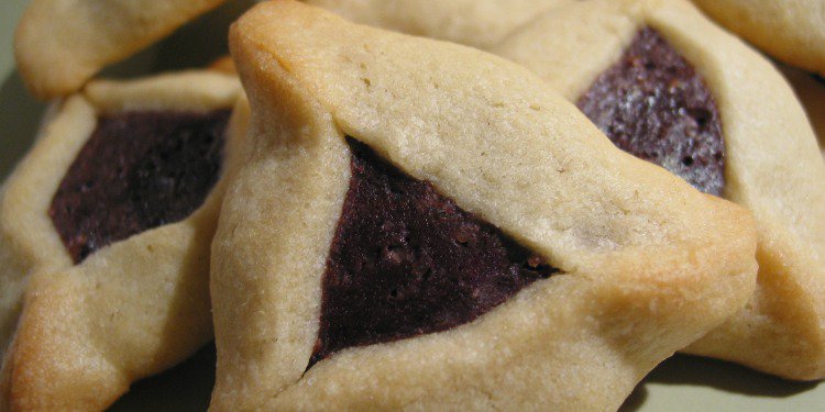 Close up image of hamantaschen on a plate.