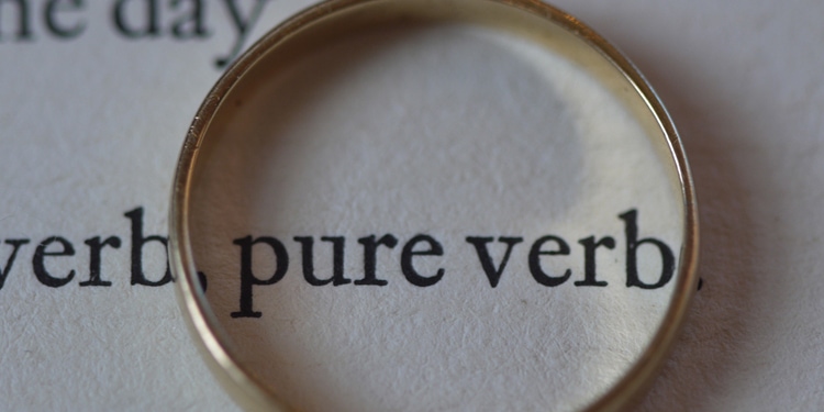 Close up image of text in a book with a ring around the words pure verb.