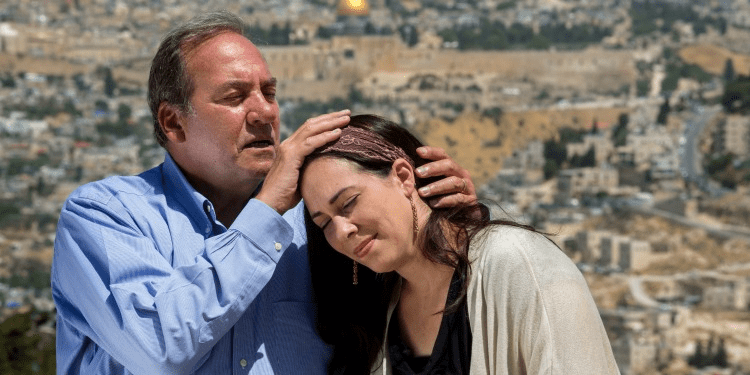 Rabbi Eckstein with his hand on his daughter, Yael Eckstein's head as he's blessing her.