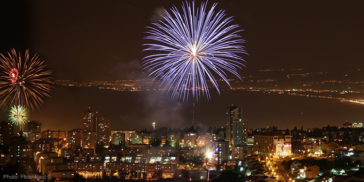 Fireworks bursting over a city.
