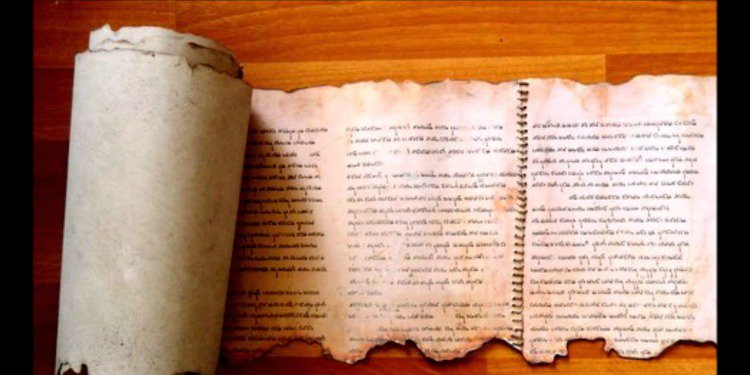 A scroll of the Jewish calendar on a wooden table.