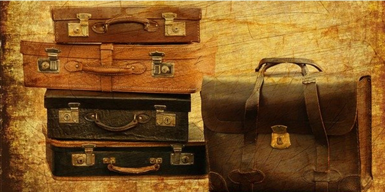 Old photo of luggage stacked on top of each other.