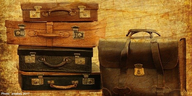 Drawing of four luggage bags stacked on top of each other next to a briefcase standing up.