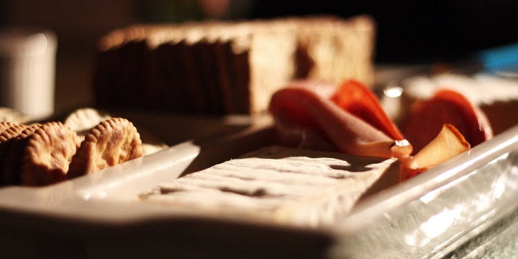 Meat, cheese, and crackers on a platter.