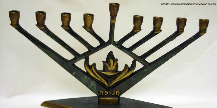 Close up image of a menorah against a white background.