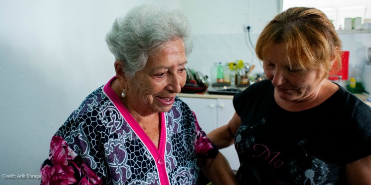 Elderly woman in Israel receiving assistance from a medical professional thanks to donations to IFCJ