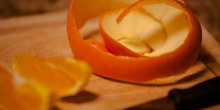 Close up image of an orange peel on a cutting board.