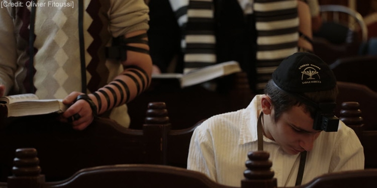 Young man praying on Yom Kippur