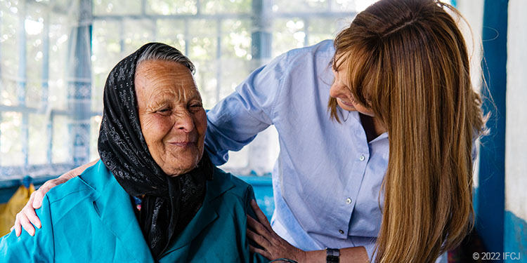 Elderly woman in black scarf with younger woman