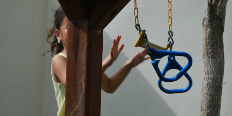 Young girl playing on a playground.