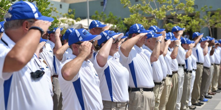 Line of US Police in blue caps and white polos and khakis in Israel.