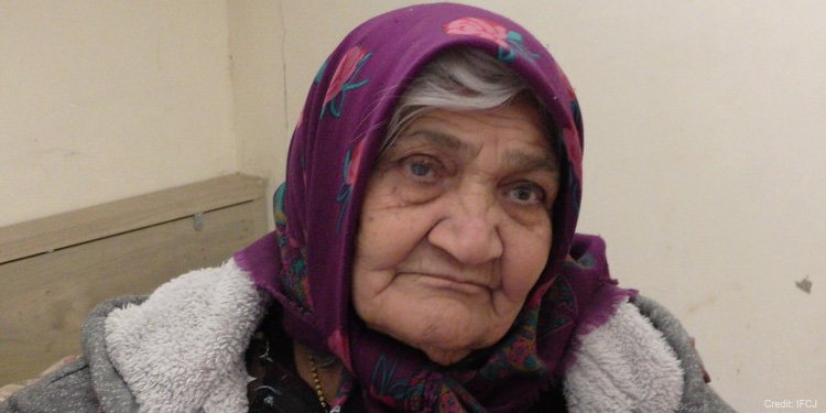 An elderly woman of Israel stares with world weary eyes