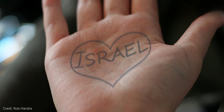 Hand with Israel in a heart written on it.