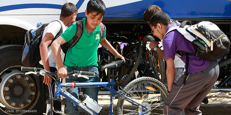 Young kids looking at a blue bike.