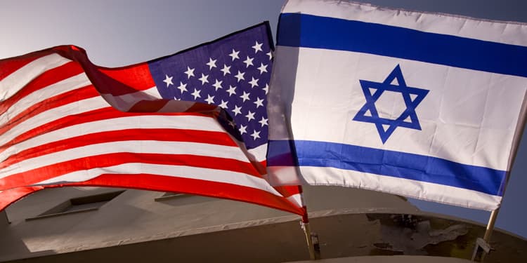 The Flag of Israel blowing in the wind next to the Flag of the United States