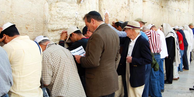 Rabbi Eckstein praying with other men at the Western Wall.