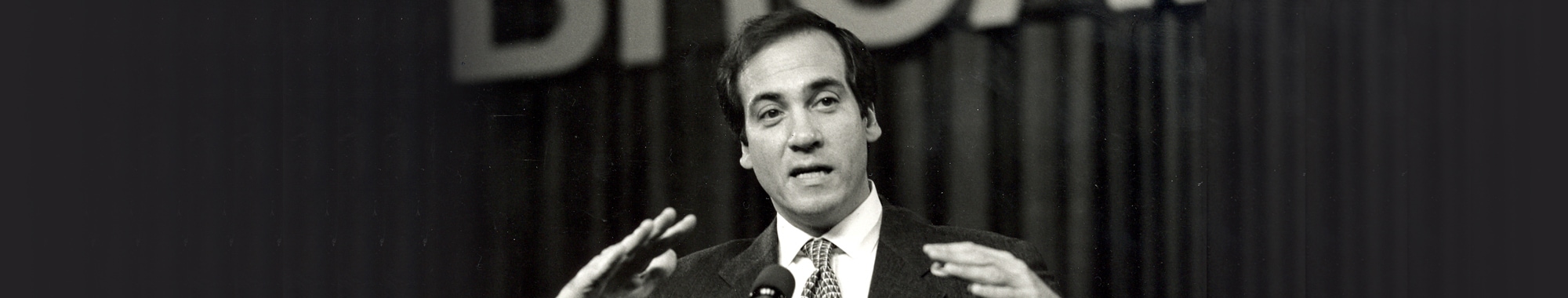 Black and white photo of Rabbi Yechiel Eckstein speaking into a microphone.