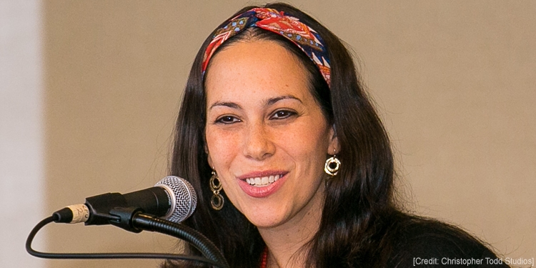 Yael Eckstein giving a speech at a podium.